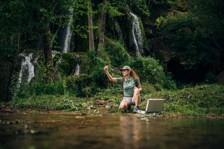 Woman Biological Researcher Taking a Water Sample